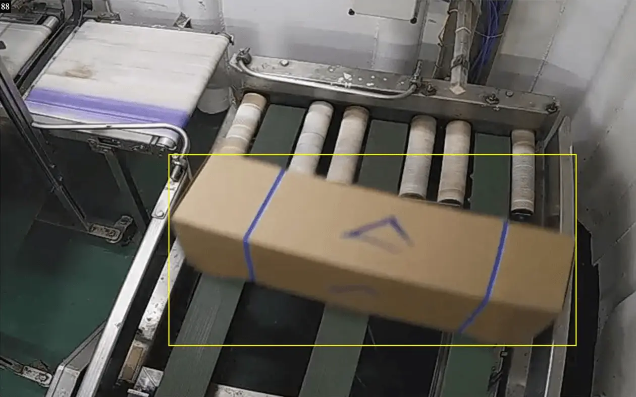 AI detection marking each counted box of frozen fish with a yellow frame as it passes along the conveyor